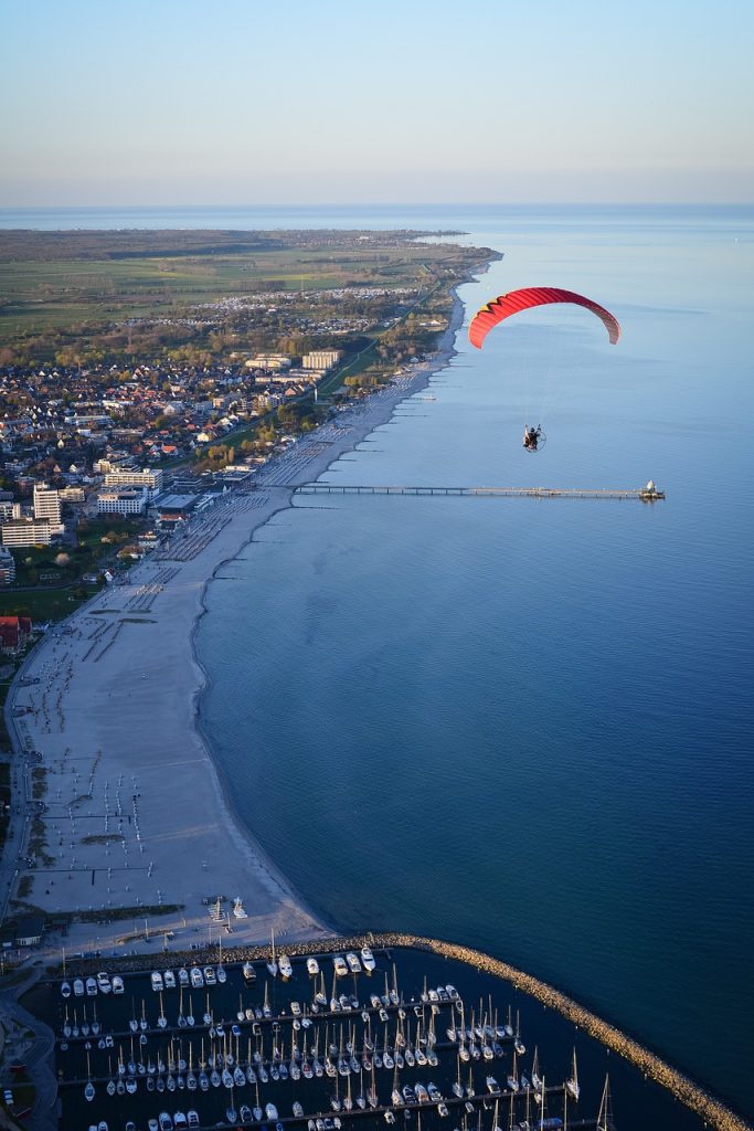 What are the top travel destinations for paragliding and skydiving?